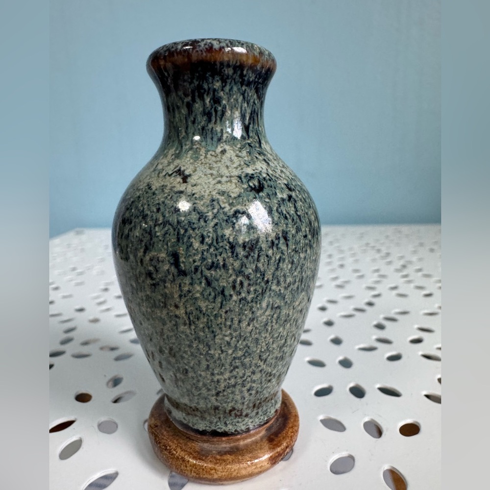 Miniature pottery vase with speckled glaze.